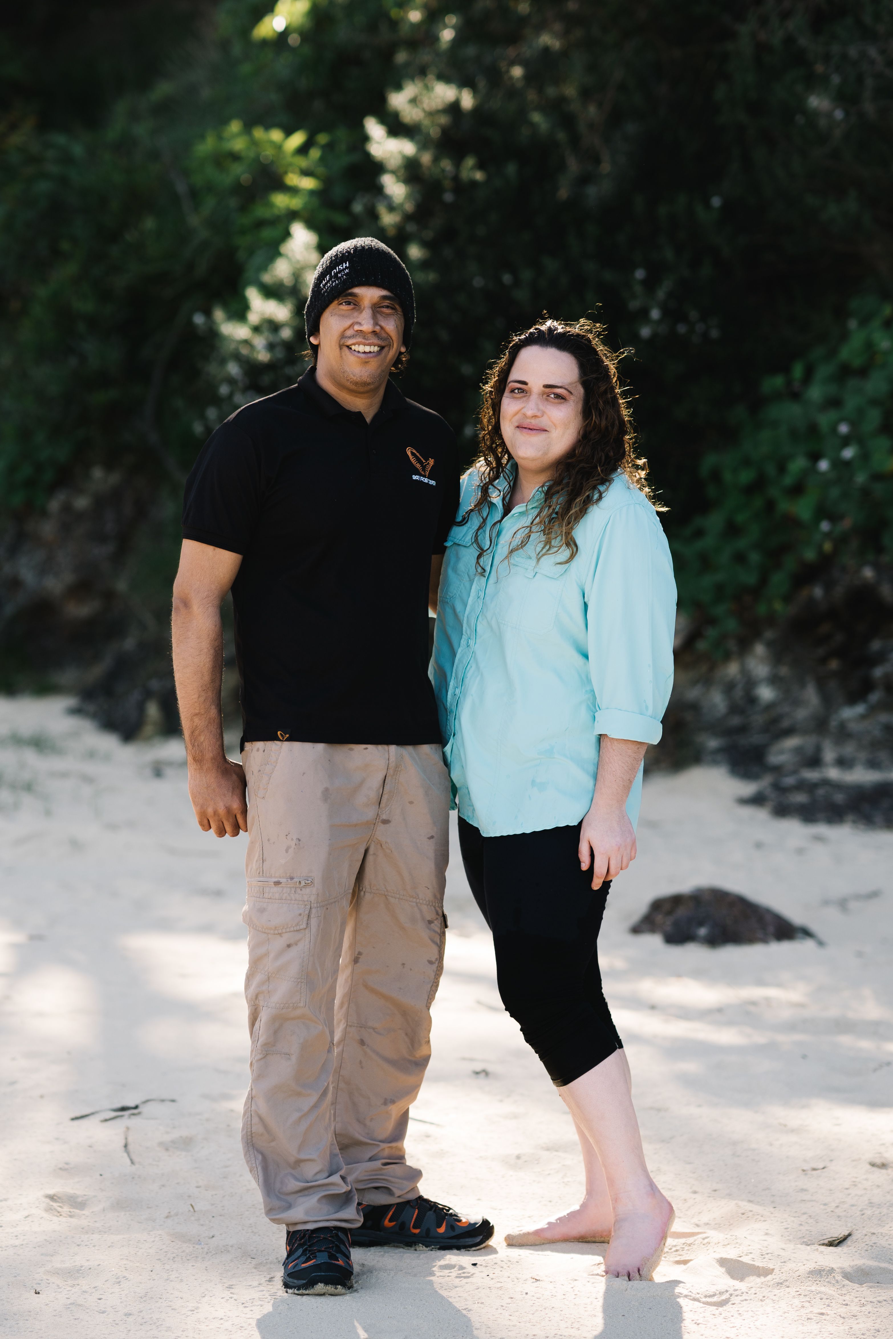 the couple standing on the beach